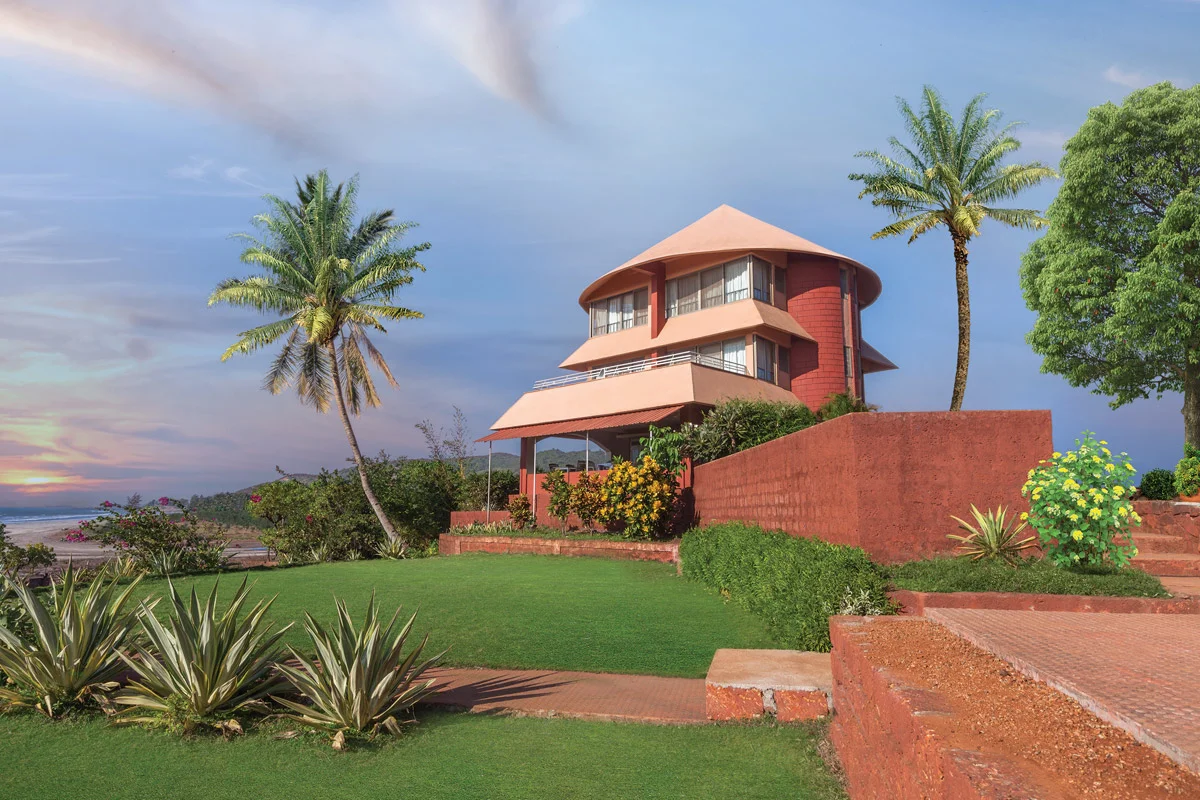Beachfront Sagar Sawali Ladghar resort building surrounded by palm trees and lush greenery overlooking Konkan’s coastline